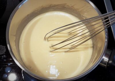 Preparing the bechamel sauce, adding milk